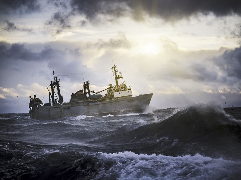 Fishing ship in strong storm.